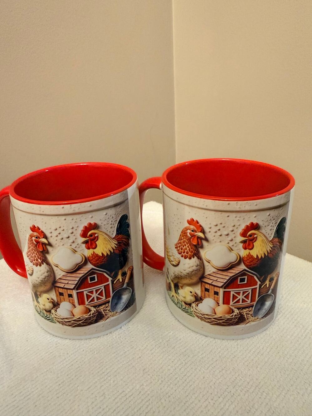 Two 10 OZ charming farm scene ceramic mugs with roosters and chickens. NWOT